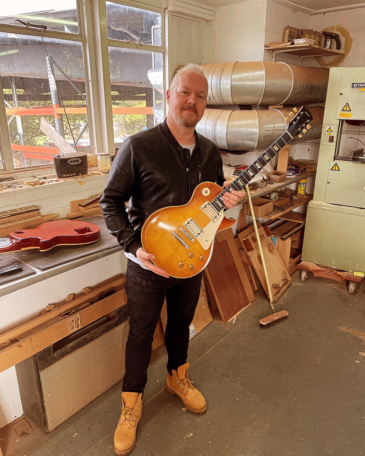 TODO: caption — in the workshop with a Les Paul